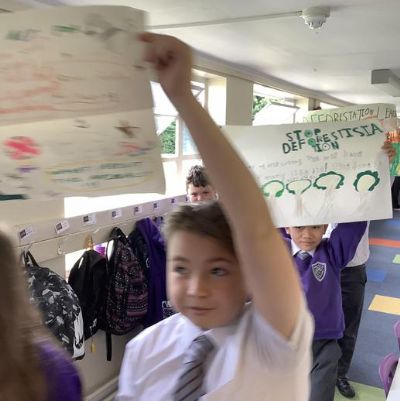 As part of our final express event, we took place in a protest around school, which ended with us protesting in the playground to stop deforestation and save the Amazon Rainforest.